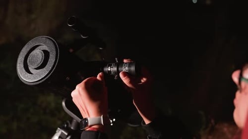 Teen Girl Adjusting Telescope at Night for Stargazing