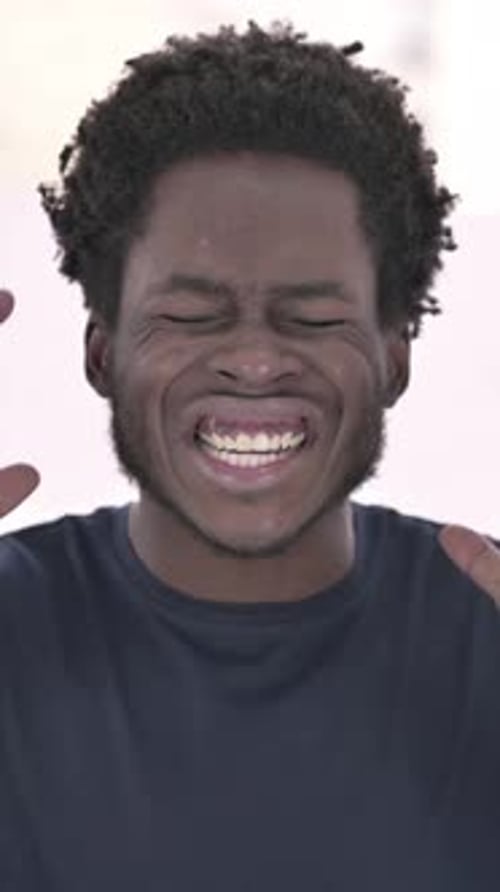 Portrait of African Man Screaming in Modern Office, vertical video