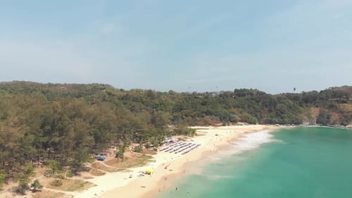 Unrecognisable people enjoying the white sand tropical beaches of Phuket, Thailand