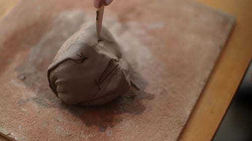 Clay Sculpture Crafted by Hand on Wooden Table