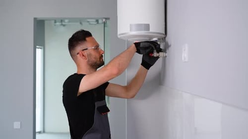 Heating Installation Technician Checks the Boiler
