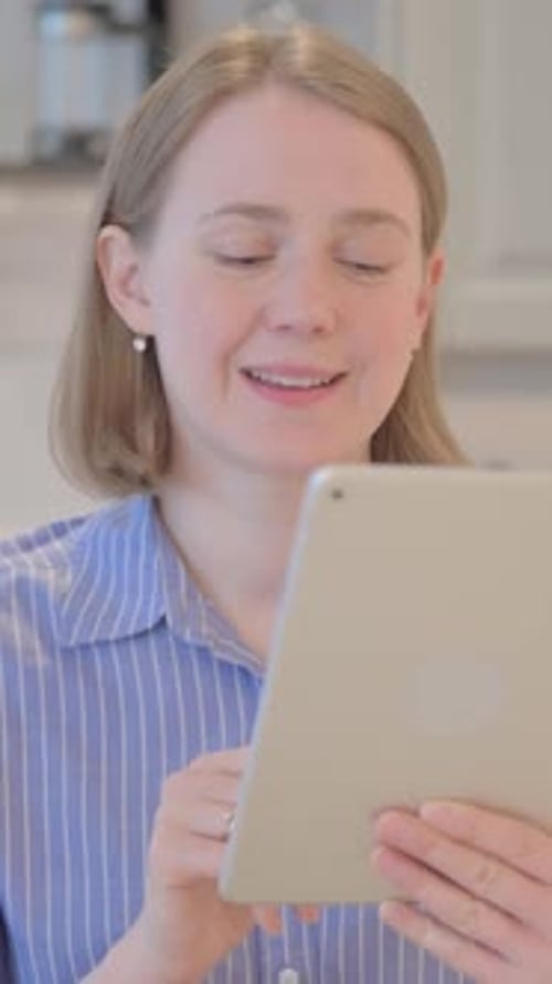 Woman Using Tablet for Video Call at Home