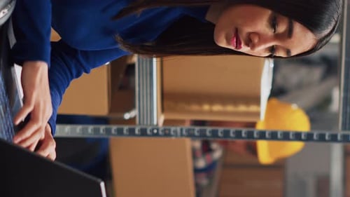 Woman Works with Laptop and Boxes in Warehouse