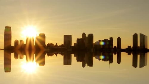 time lapse of sun going down behind the city. skyline cityscape panorama