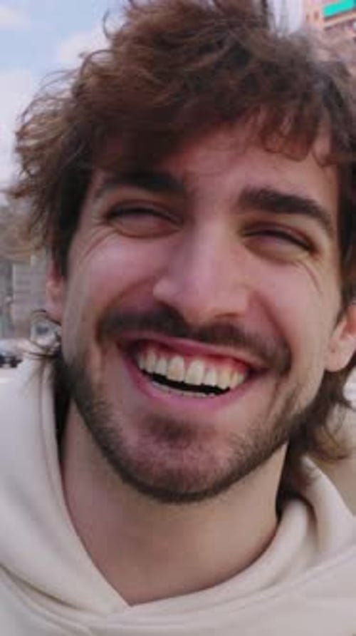 Young Adult Man Smiling Brightly in City Close Up