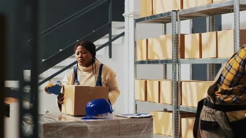 Warehouse Employees Packing Boxes for Delivery