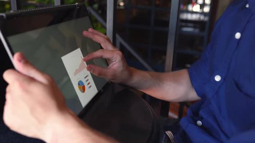 Man Reviews Data on Touchscreen Computer