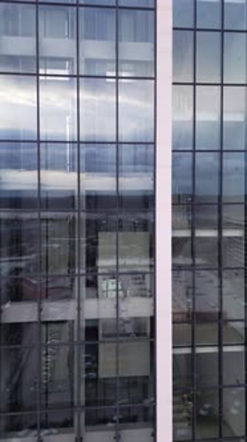 Aerial View of Moving Elevator Walls and Windows of Contemporary Business Center at Evening