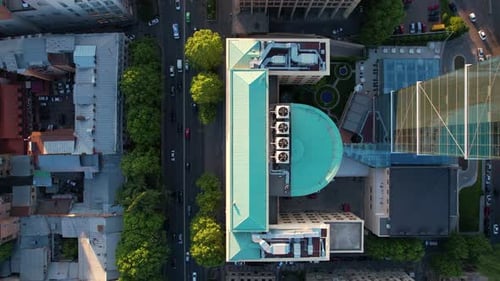Traffic In The Street And Building Roofs