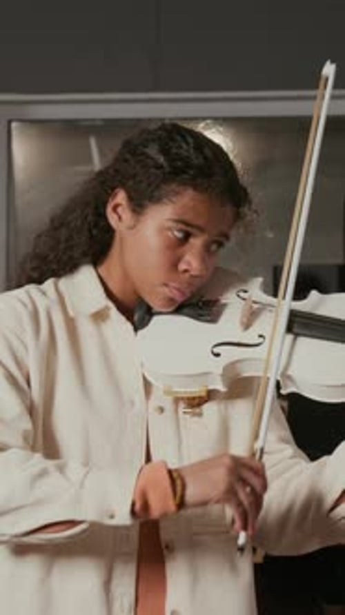 Adolescent Girl Wearing Milky-Coloured Shirt Playing Violin in Music Studio