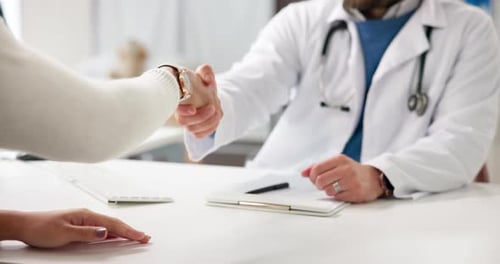 Doctor, people and meeting with shaking hands in office for consultation