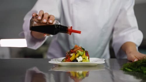 Chef Drizzling Balsamic Vinegar on Fresh Salad