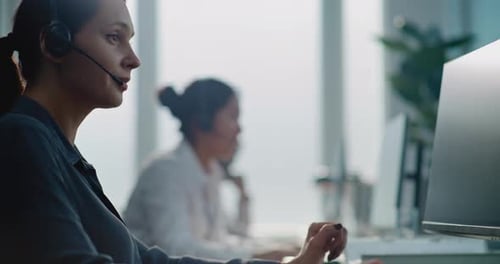 Caucasian Female Technical Customer Support Operator Working on Computer Talking on Headset