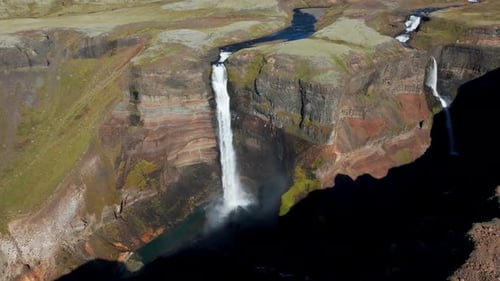 Haifoss Waterfall Flowing Down The Mountain Cliff In Summer In Iceland. - aerial shot