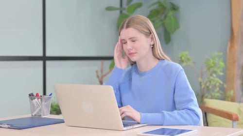 Young Adult Woman Working at Computer with Headache