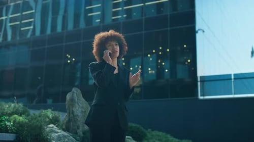 Stylish Woman Talking on Phone Outside Office Building