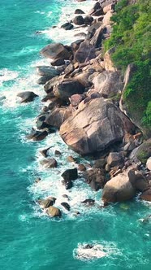 Scenic view of rocky coastline and turquoise waters. Vertical video