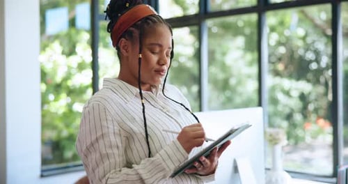 Focused Woman Working on Tablet in Modern Office