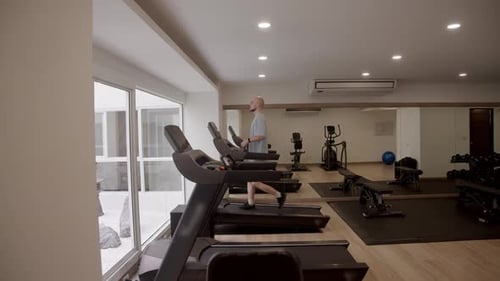 Cardio Training Concept with Multiple Machines in Row Strength Zone in Background and Everyday