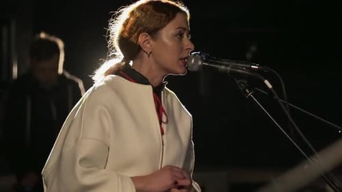 A Young and Pretty Singer Emotionally Sings Into the Microphone Soloist Rock Group Expressive with