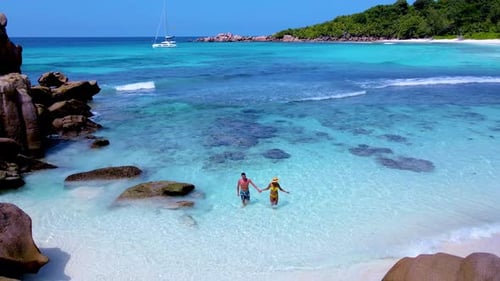 Exploring the Serene Shores of Seychelles While Walking Hand in Hand