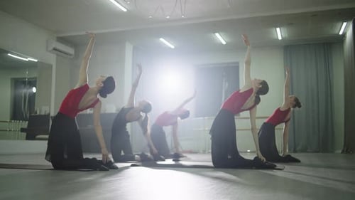 Five Women Stretch in Dance Studio