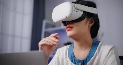 Woman Interacts with Virtual Reality Headset at Home