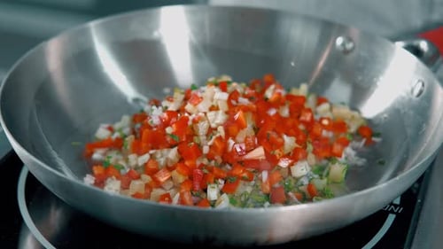 Cooking Diced Vegetables in Stainless Steel Pan
