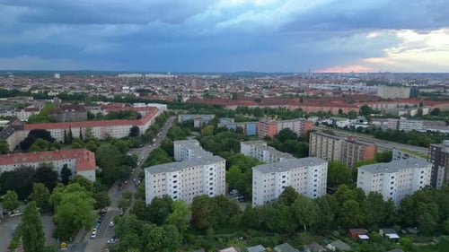 Football Soccer field fields surrounded by urban cityscape with setting sun casting a warm glow. Gre