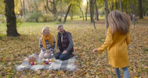 Happy Family Having Autumn Picnic in Park