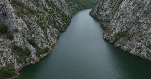 Aerial Pullback Rugged Narrow Canyon - Hydroelectric Reservoir Water