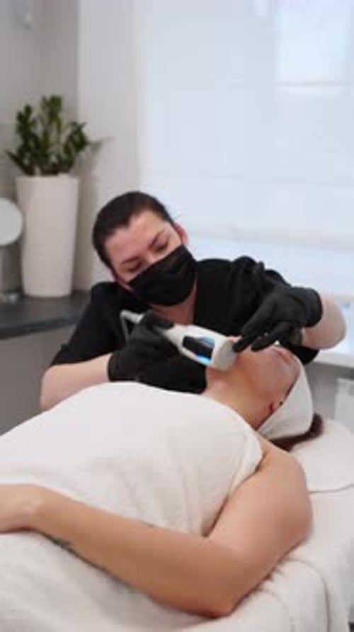 Woman Receives Rejuvenating Facial Treatment at Clinic