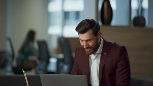 Adult Male Working on Laptop in Office