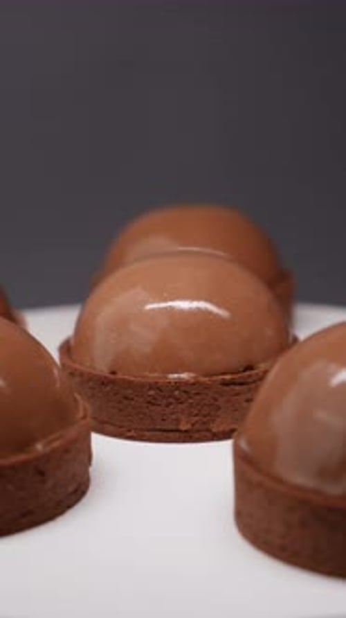 Shiny Chocolate Dessert Tarts on White Surface