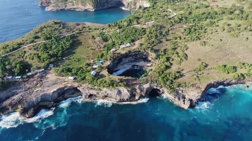 Drone footage capturing Broken Beach on Nusa Penida, Bali, Indonesia, showcasing the natural arch, c