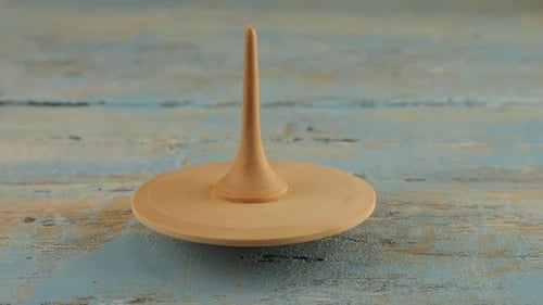 Wooden Spinning Top Spinning on Wood Surface