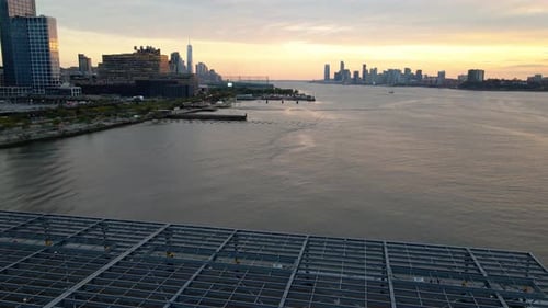 Aerial view of the Hudson river and the Hudson Yards skyline, dusk in New York City - pan, drone sho