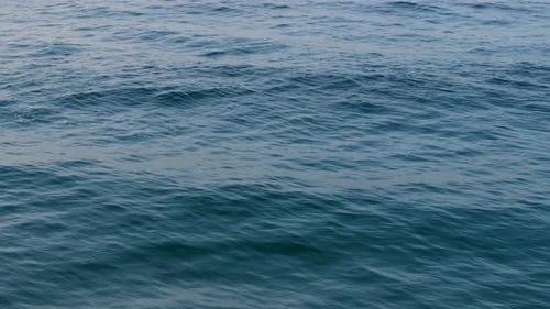 Surface Of Blue Ocean With Calm Waves. - close up shot