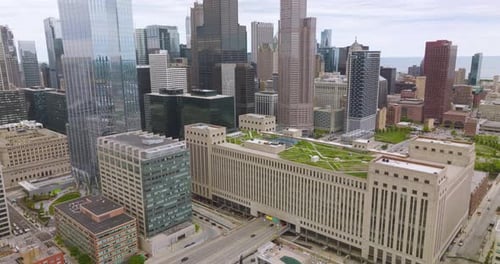 Multi-lane road passing through the multi-storied building with green zone on top.
