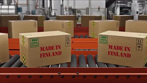 Vegan Food Cargo Boxes Made In Finland Text On Roller Conveyor