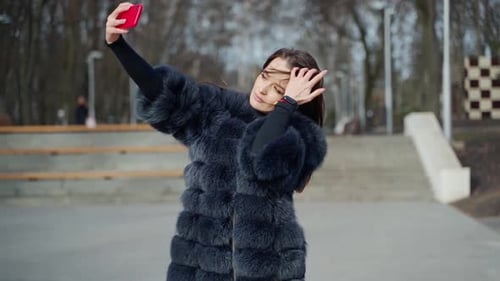 Young woman taking selfie. City stylish portrait of beautiful woman making selfie at the street
