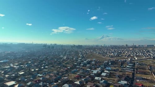 A cityscape with a mountain in the background