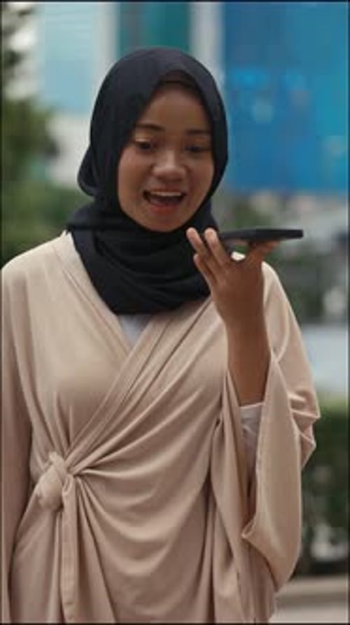 Vertical Video Pretty Young Woman Making Voice Message While Standing Outside
