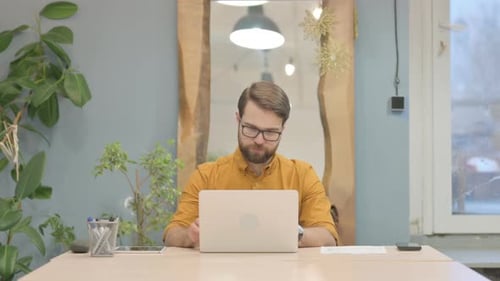 Young Businessman Leaving Office after Completing Work