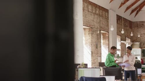 Business professionals discuss over documents in a bright office with copy space