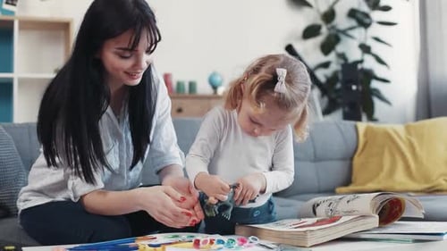 Woman and Child Playing with Toys Indoors