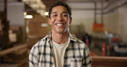 Face, carpenter or man with happiness in workshop, manufacturing and production with pride