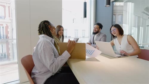 A Diverse Group of Professionals is Actively Collaborating in a Modern Office Environment