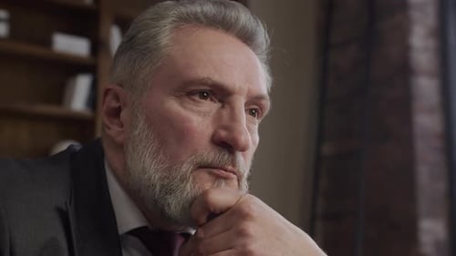 Contemplative Senior Businessman in Office Close Up