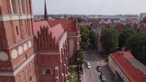 Drone Flight Around the Ancient Cathedral in the Center of the Old European Town with Tile Roofs